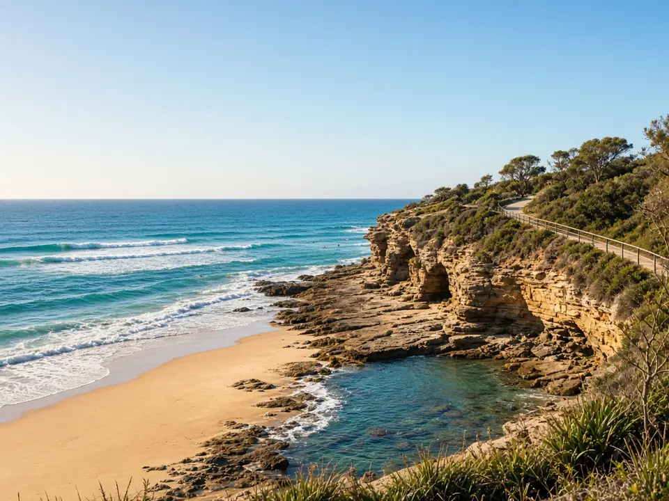 A surf beach with a coastal cliff walk and rock pool